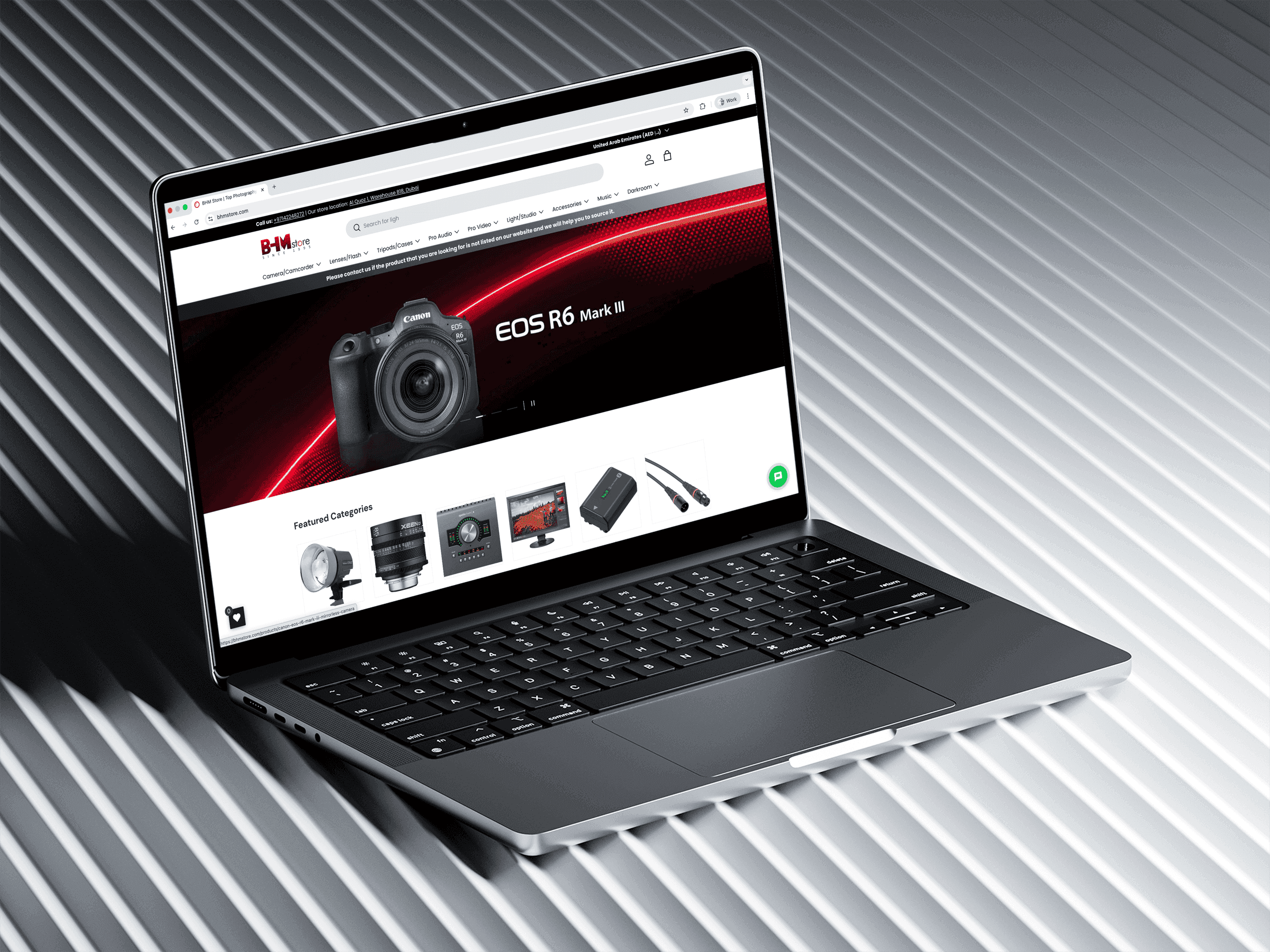 The BHM Store home page open in a browser on a laptop: a Canon EOS R6 Mark III banner above a row of featured categories — lighting, cine lenses, an audio interface, a monitor and cabling.